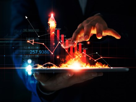 Business growth. Businessman holding tablet and a hot of fire glowing upright arrow with analysing data and economic growth graph. Strategy. Stock market. Financial and banking. Digital marketing.