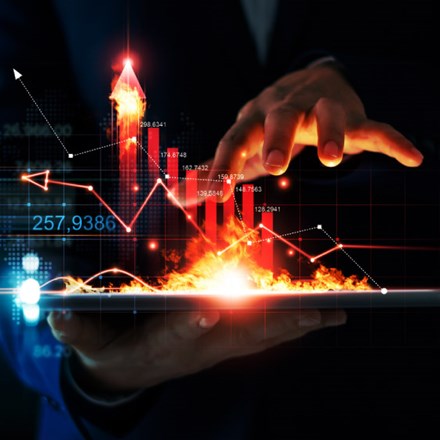 Business growth. Businessman holding tablet and a hot of fire glowing upright arrow with analysing data and economic growth graph. Strategy. Stock market. Financial and banking. Digital marketing.