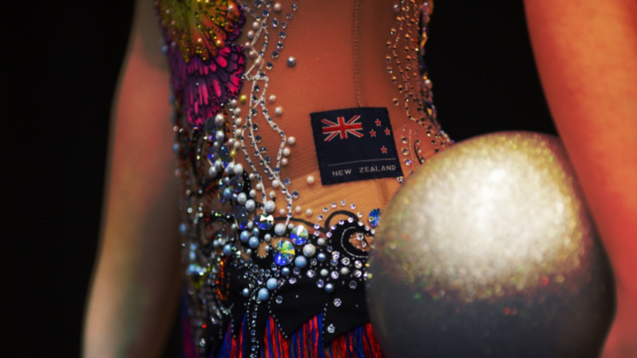 Macro image of NZ rhythmic gymnast holding a silver ball.