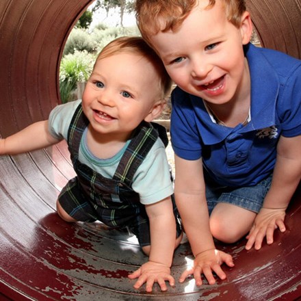 Two children playing in a tunnel, background image