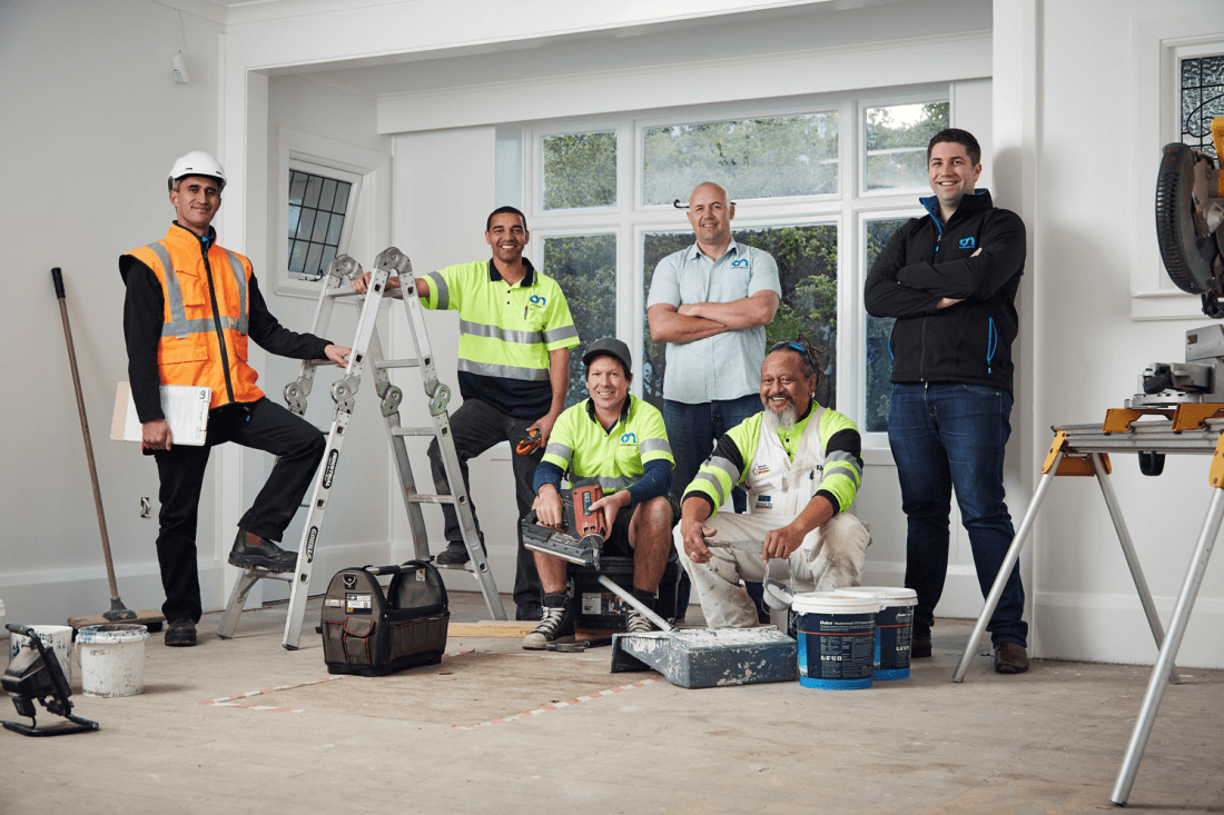 A group of different tradies posing for the camera. 