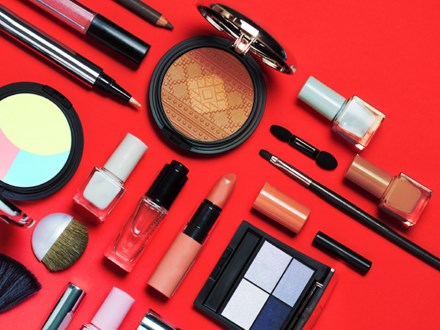 Beauty, decorative cosmetics, flat lay, top view, minimalistic style with red background.