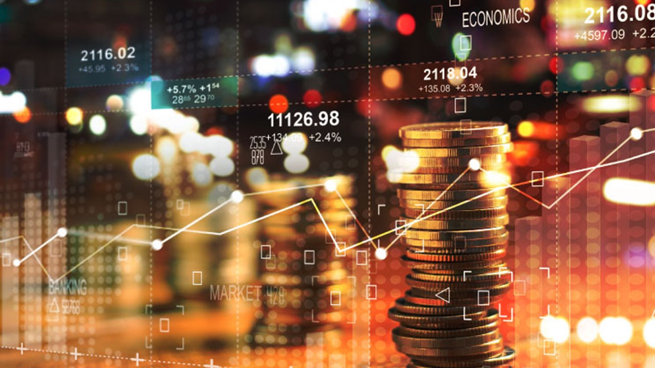 Double exposure with business' charts of graph and rows of coins for finance at night city background.