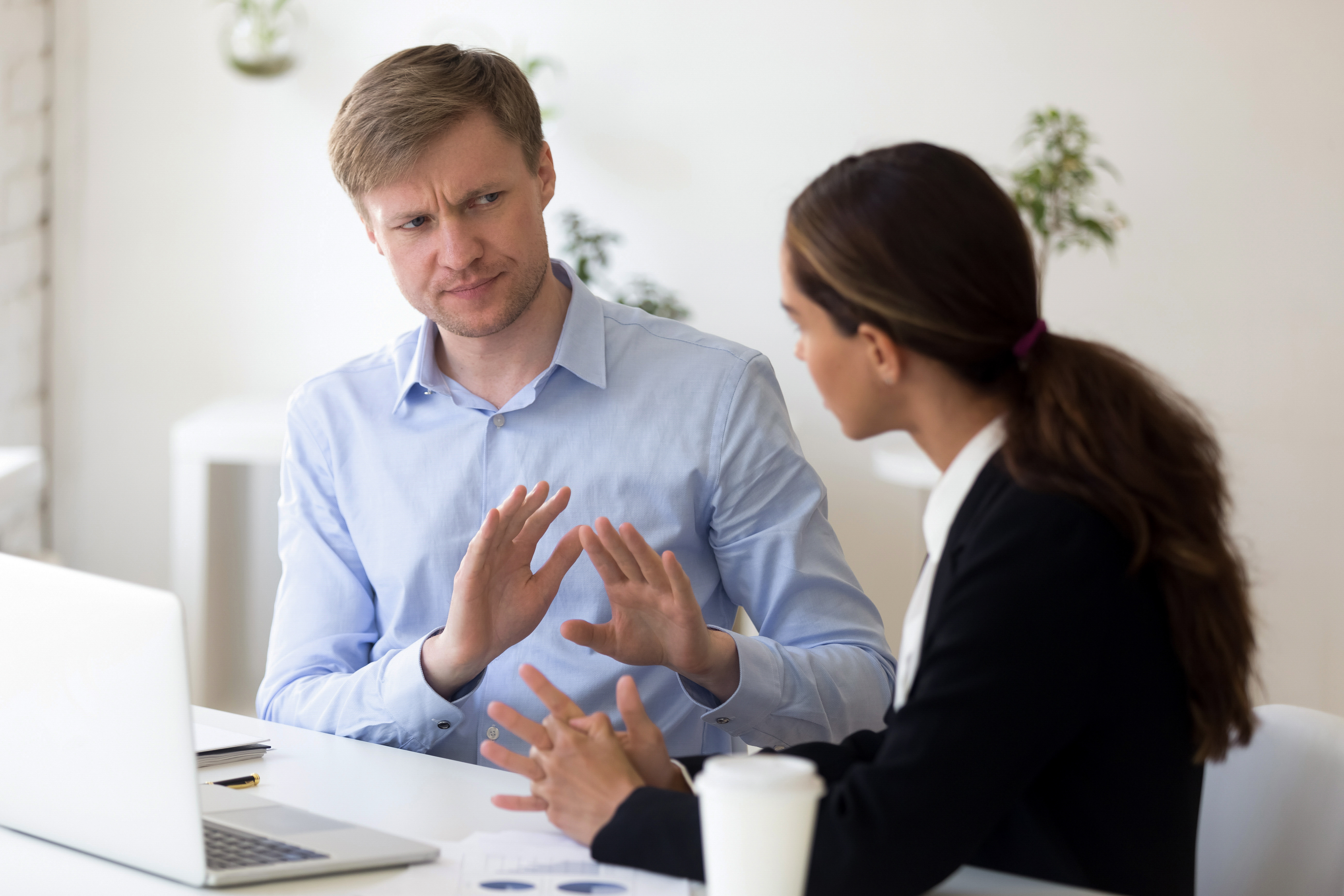 Man disagreeing with co-worker