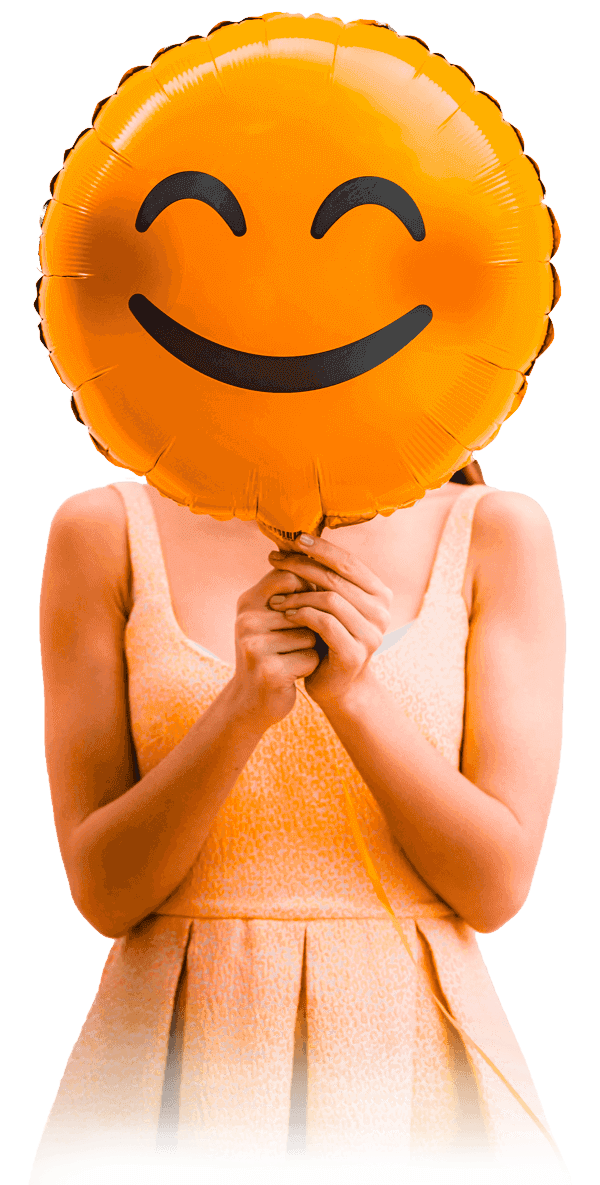 Girl with happy emoji balloon in front of her face
